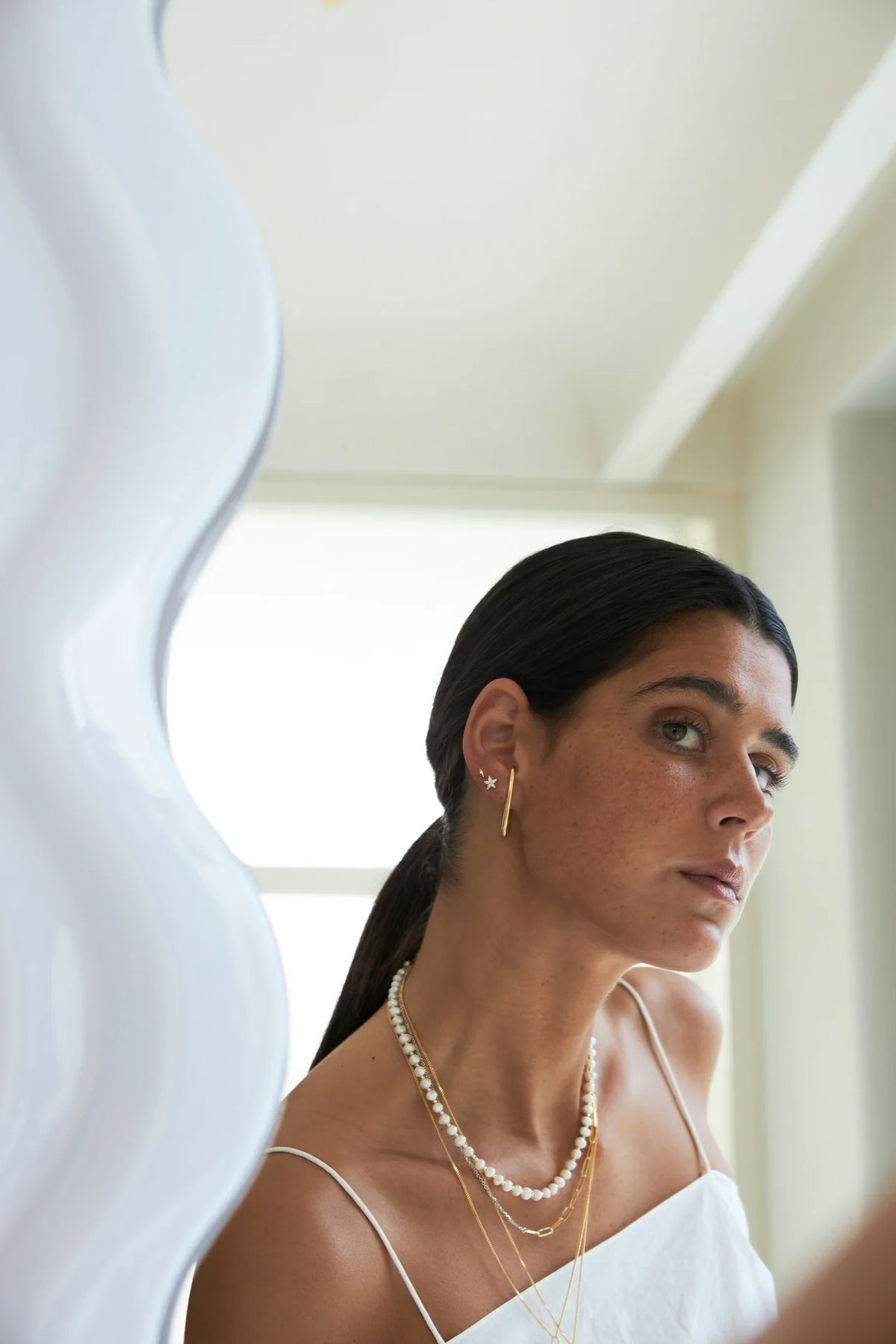 elegant ear stack tips with layered necklaces and earrings in modern style