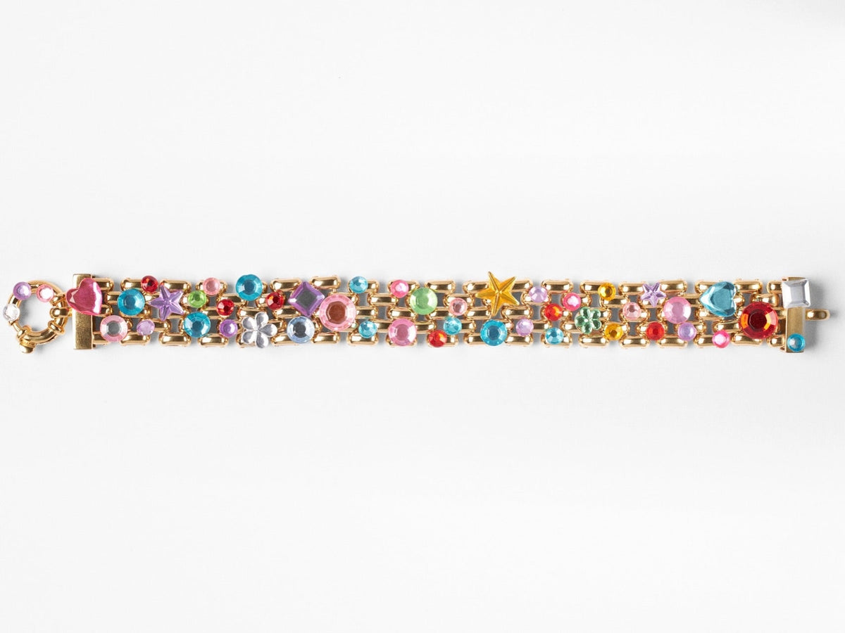 A gold-tone chain bracelet heavily embellished with colorful rhinestones and star-shaped accents, shown vertically against a plain white background.