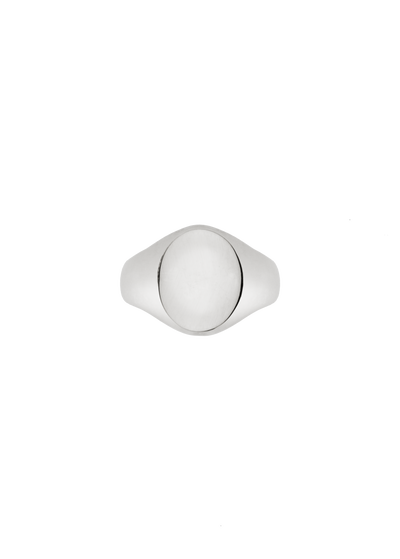 A silver signet ring with a smooth, polished oval face, photographed from directly above on a solid white background.