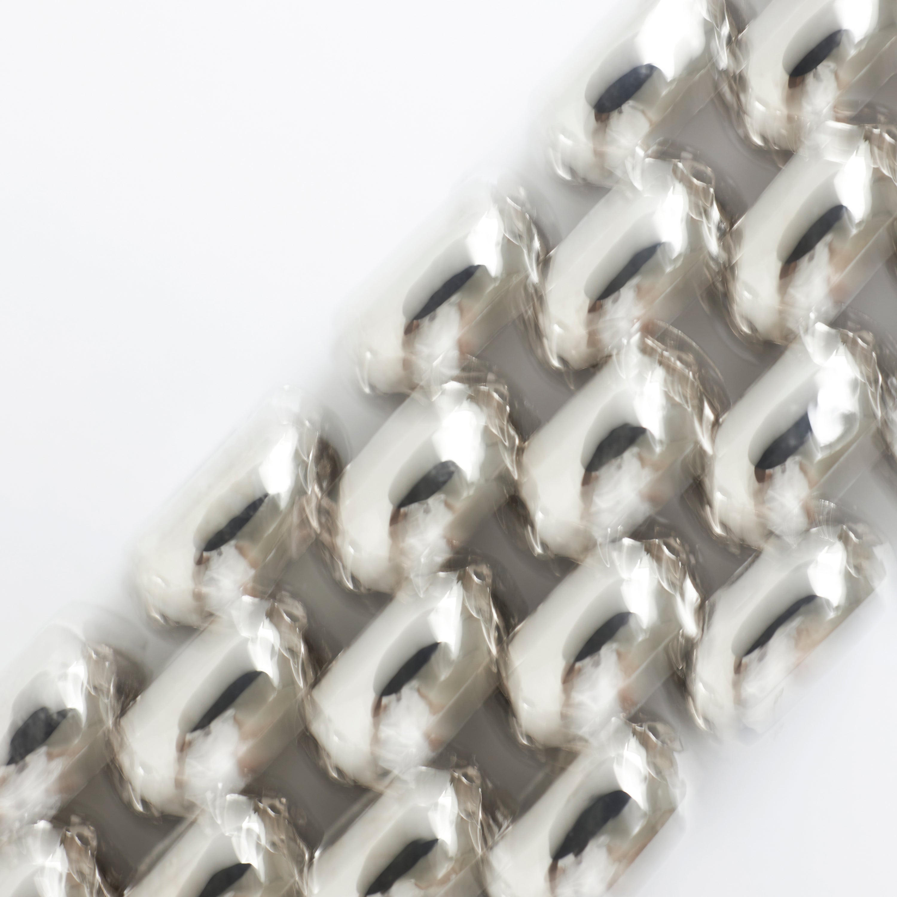 Close-up of a woven metal mesh with a white background