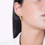 model wearing almost fiona earrings in gold