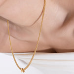 model wearing alphabet necklace with pendant A in gold