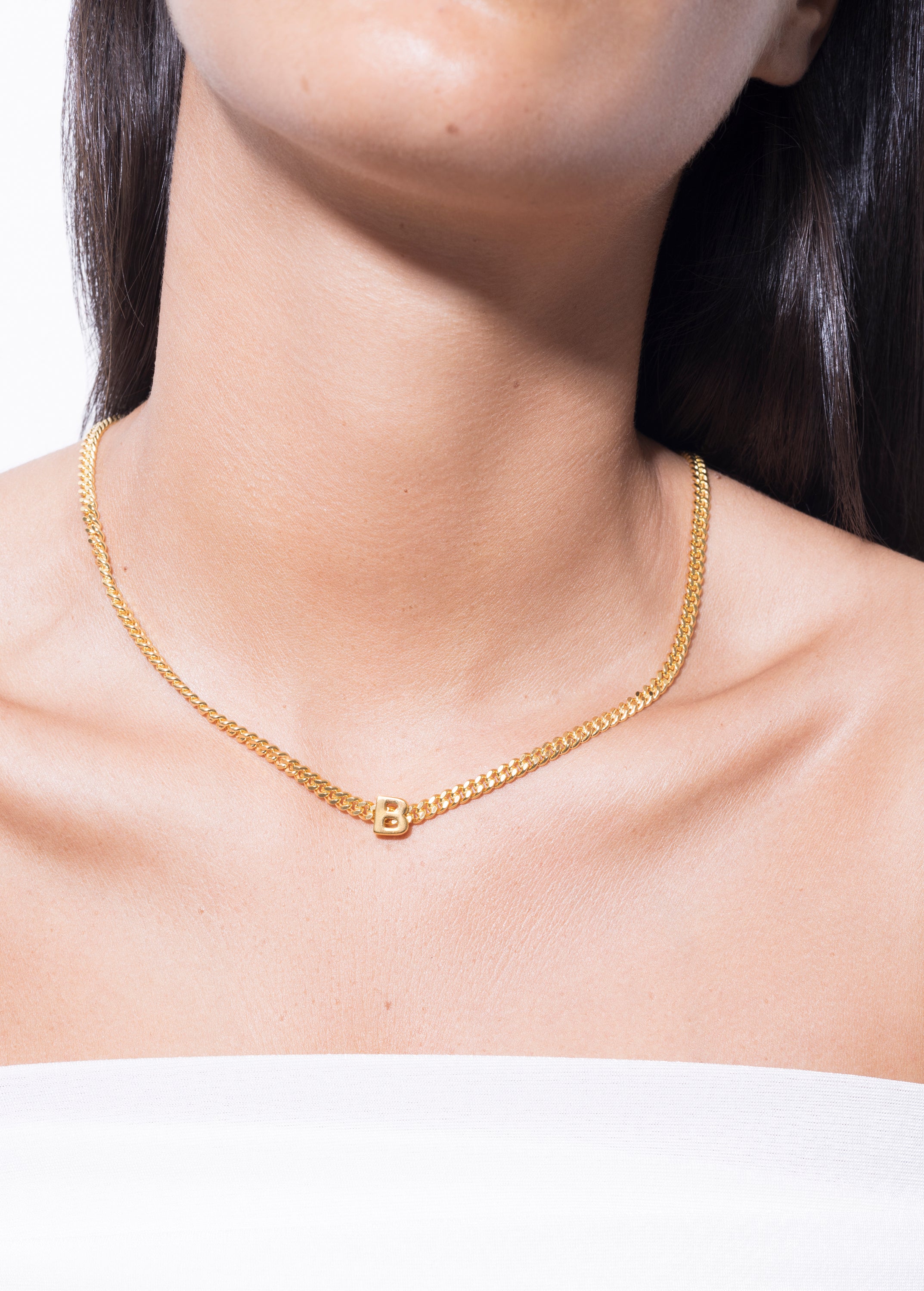 model wearing alphabet necklace with pendant B in gold