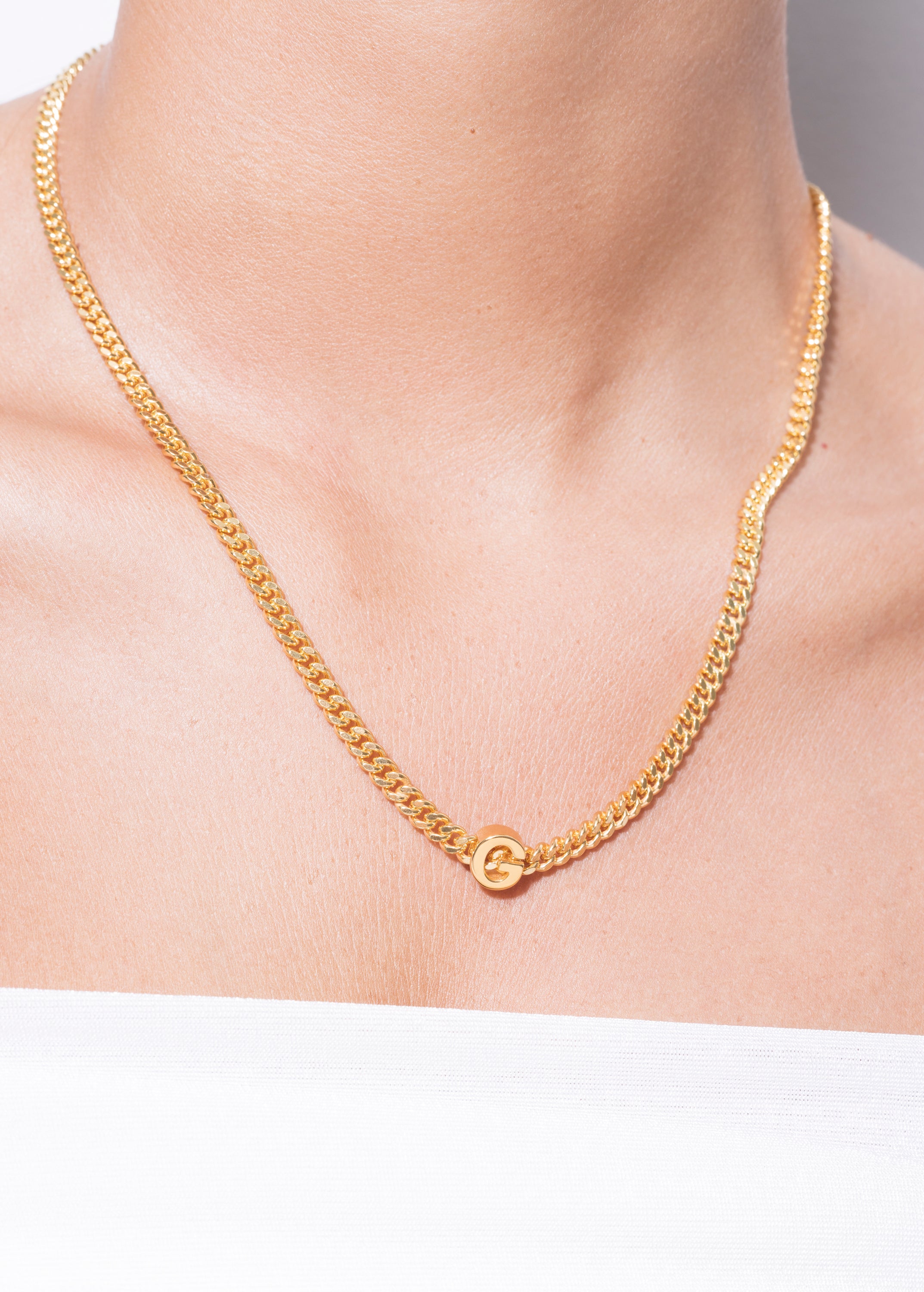 model wearing alphabet necklace with pendant G in gold