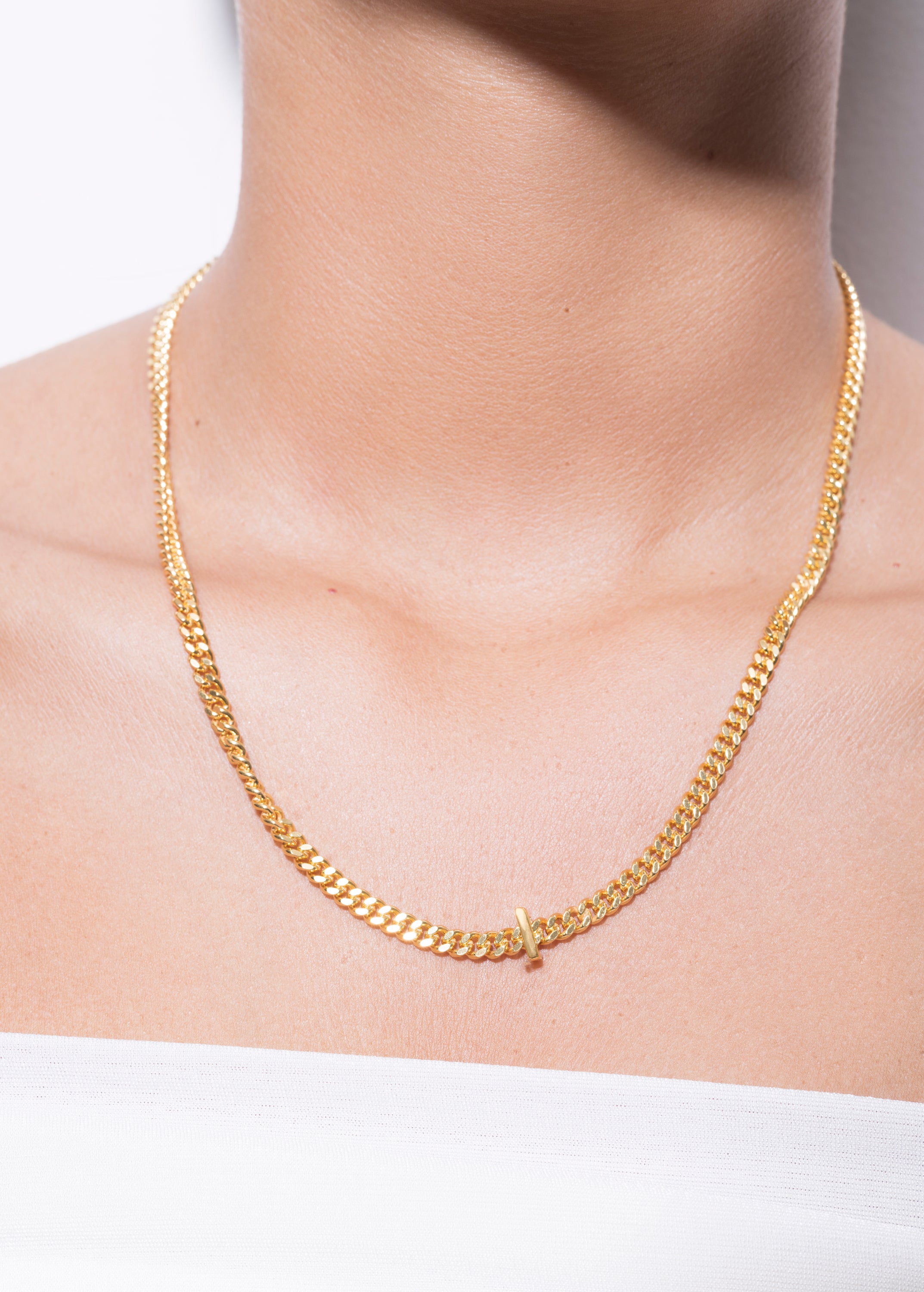 model wearing alphabet necklace with pendant I in gold