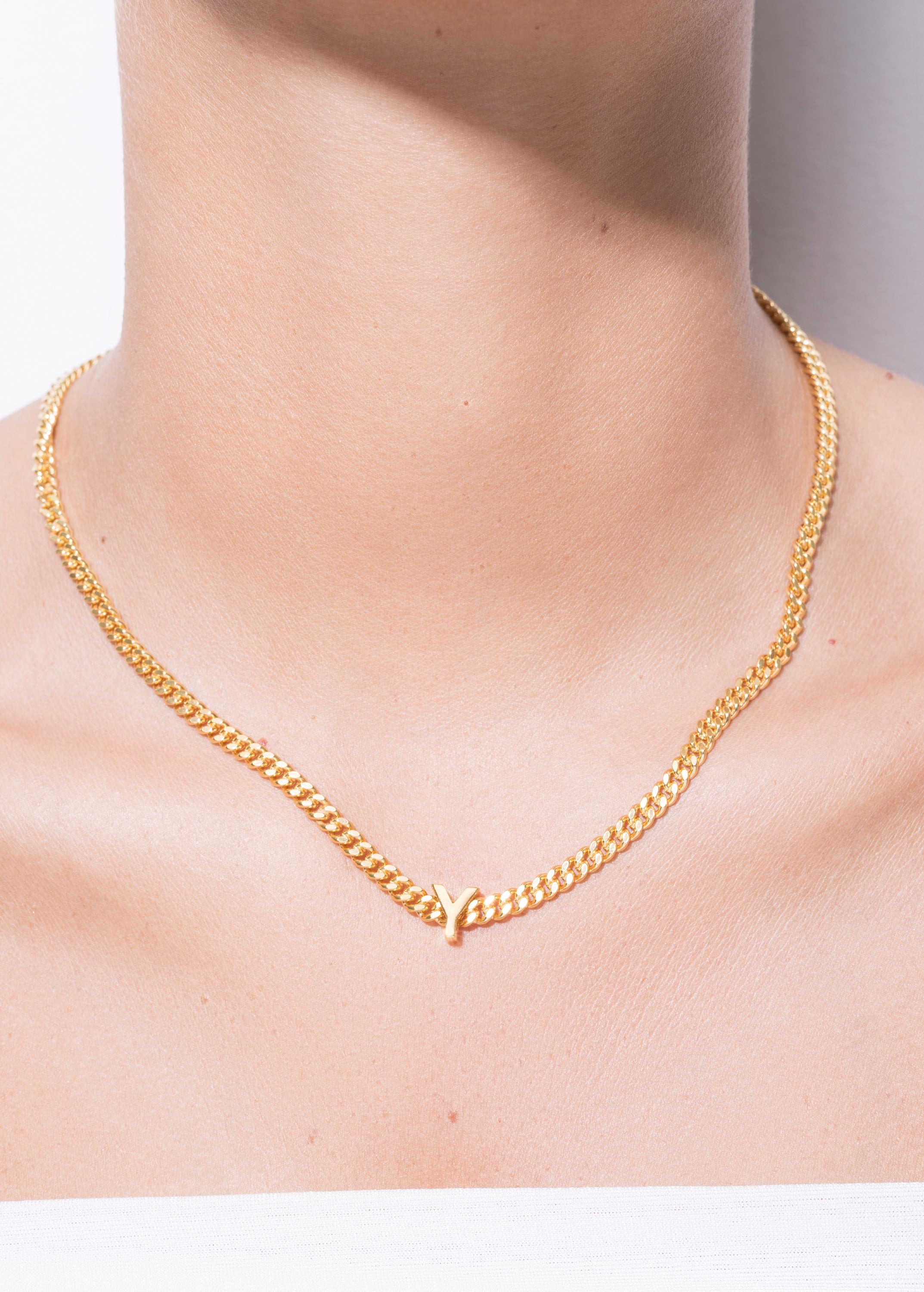 model wearing alphabet necklace with pendant Y in gold