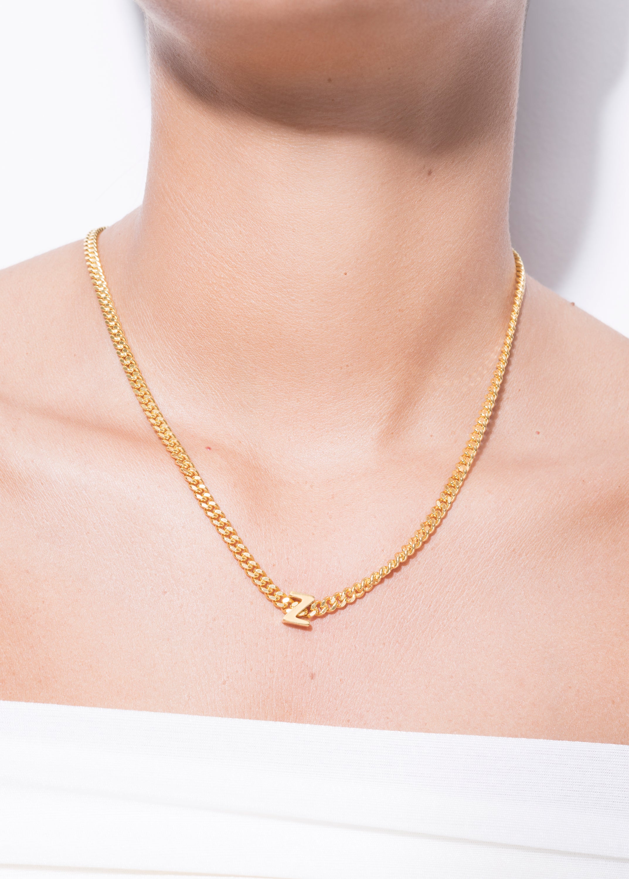 model wearing alphabet necklace with pendant Z in gold