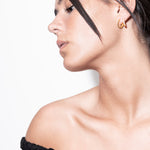 model wearing amina double layer earrings in gold