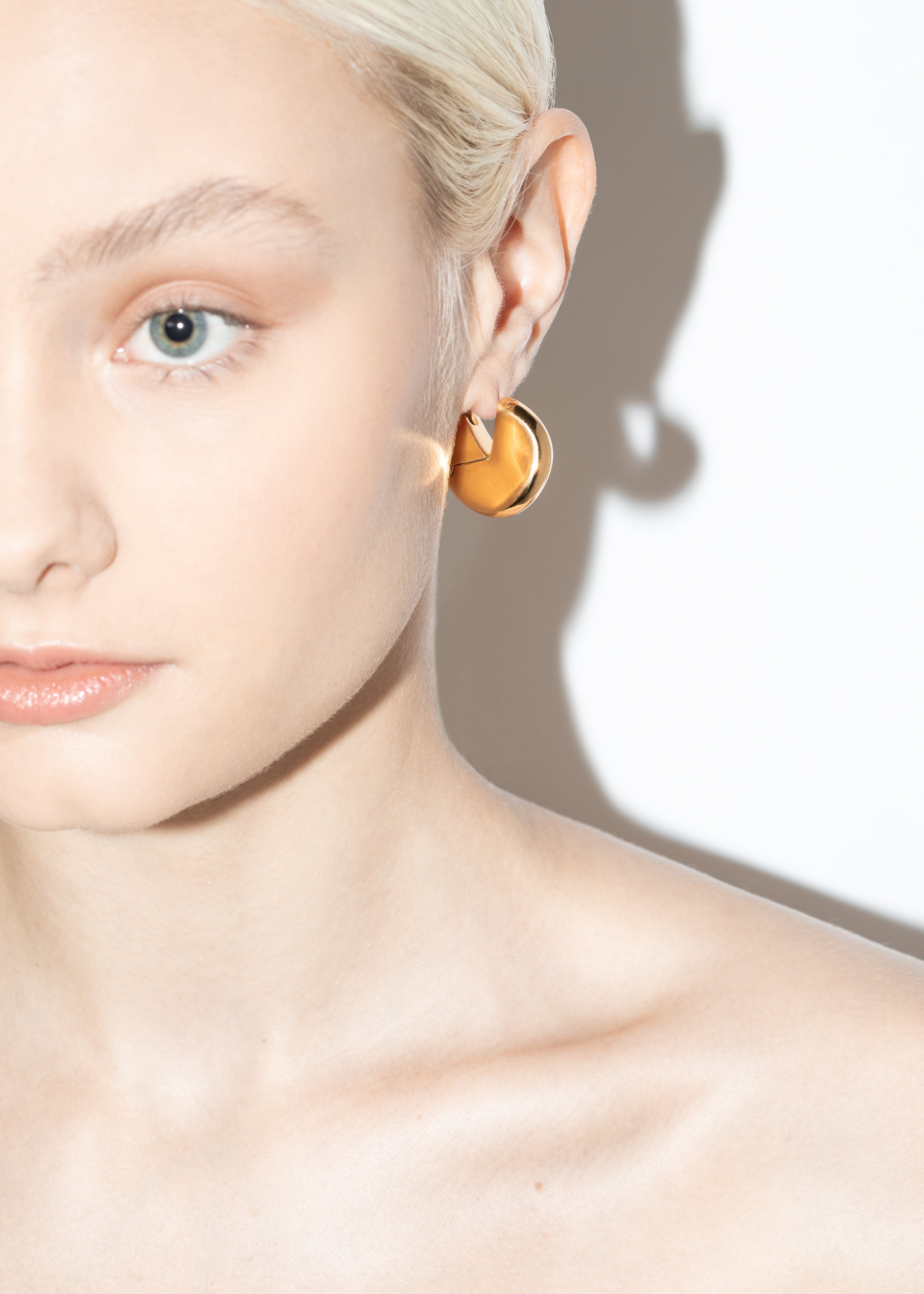 model wearing bailey earrings in gold