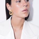 model wearing claudine earrings in gold