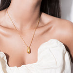 model wearing constantin necklace in gold