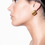 model wearing daphne earrings in gold