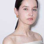 model wearing fiona brushed earrings in gold