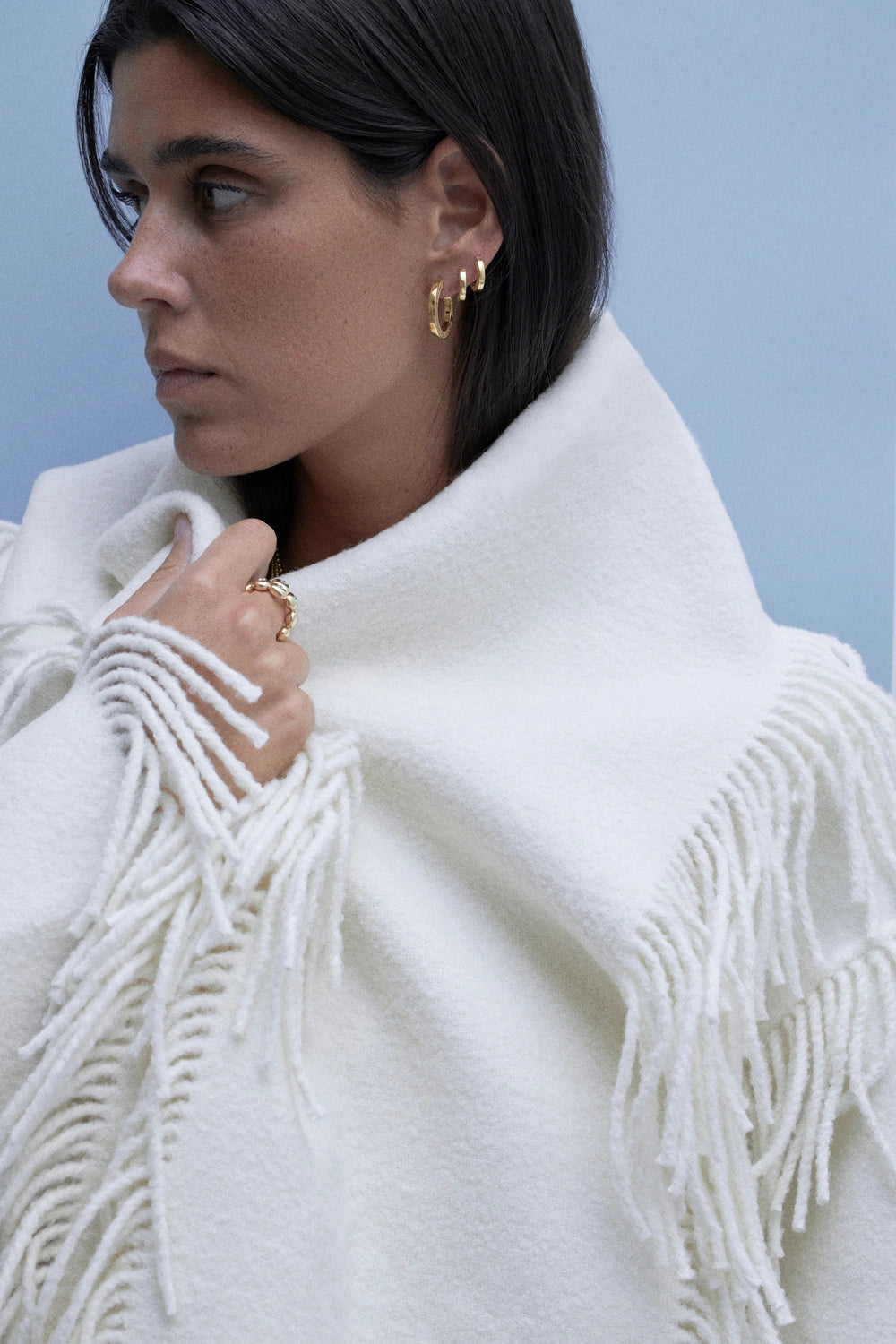 model wearing engravable hoops earrings and 18k ring with diamonds