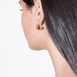 model wearing gina earrings in gold