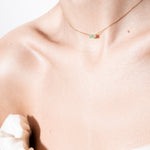 model wearing hannah necklace 18k emerald