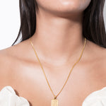 model wearing jodie shaped necklace in gold