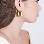 model wearing magda earrings in gold