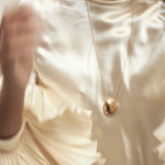 model wearing chéri long necklace in gold