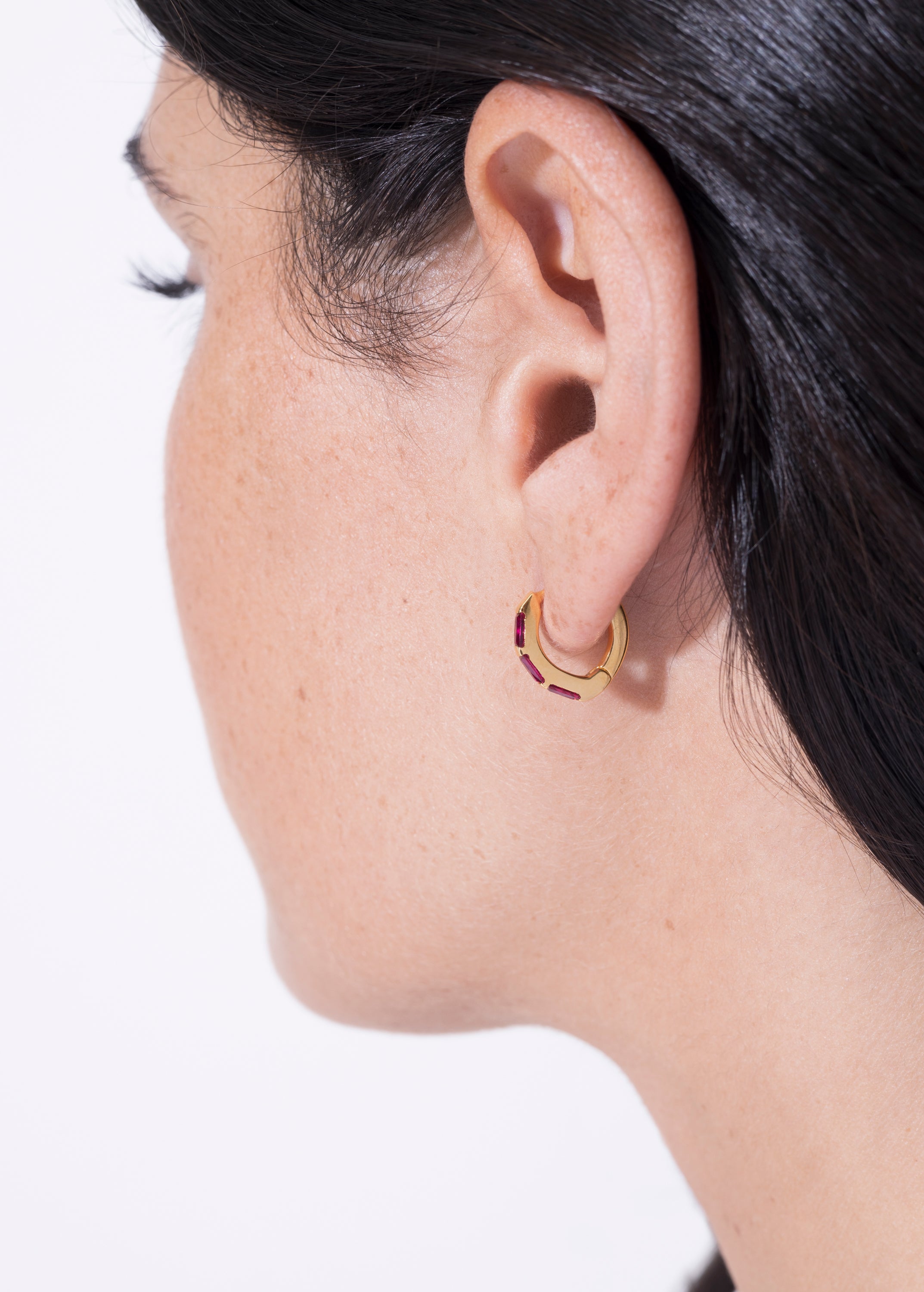 model wearing norma earrings rubi in gold