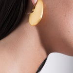 model wearing pam earrings in gold