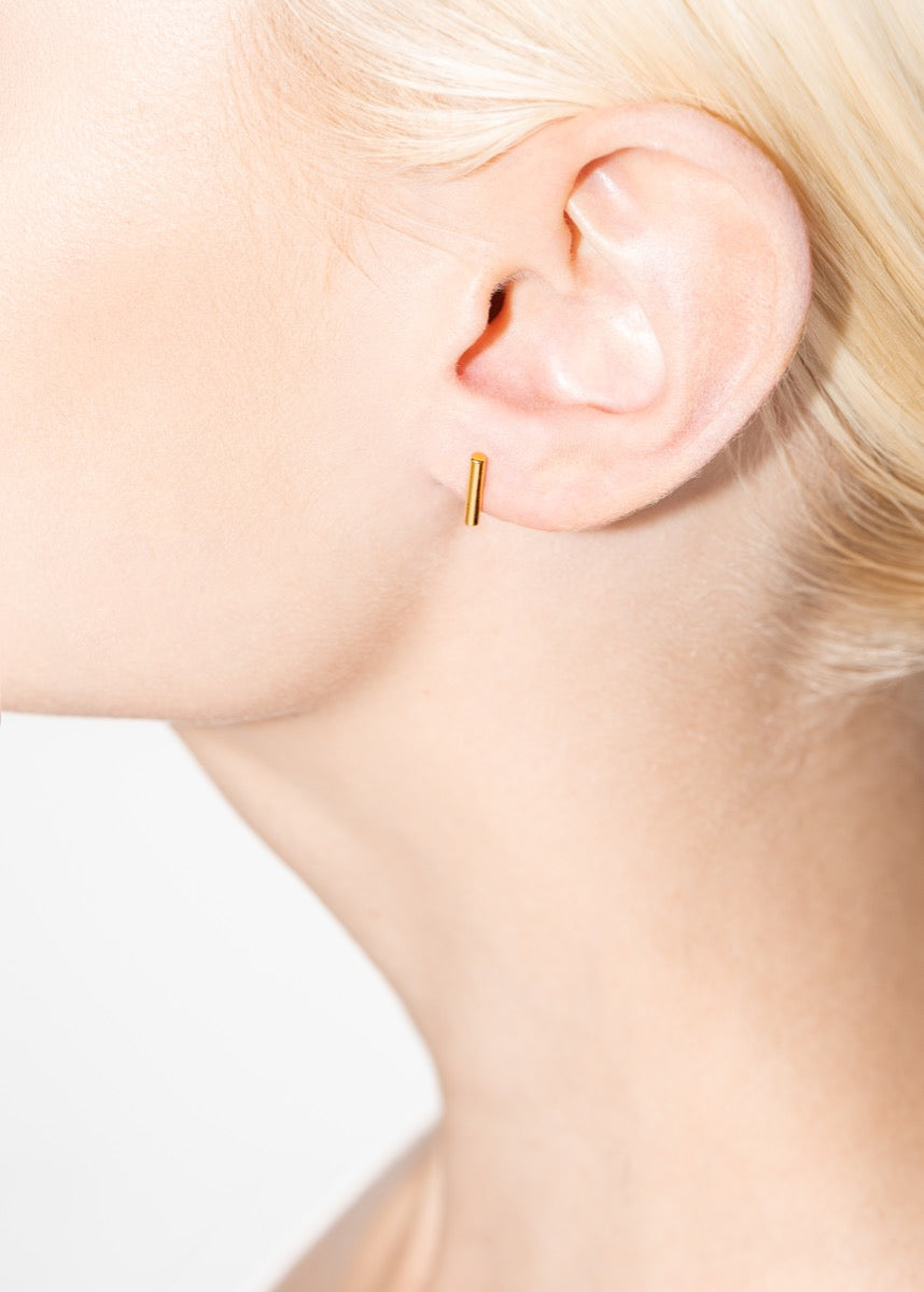 model wearing royals earrings in gold