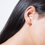 model wearing sade earrings in gold