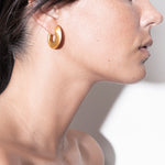 model wearing sarah earrings in gold