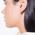 model wearing sarah mini earrings in gold