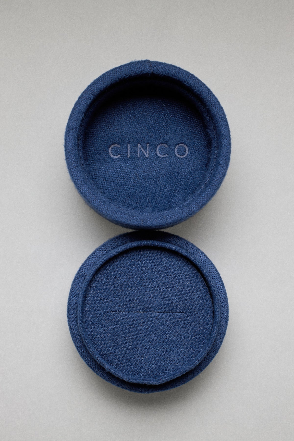 Tiny velvet jewelry box in navy blue, showcasing elegant design for memorable gift presentations.